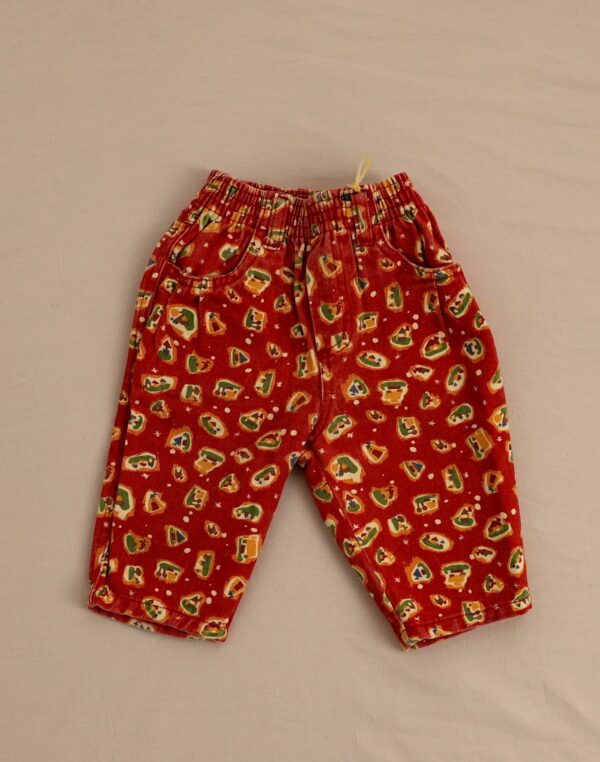 Red denim pants with house pattern