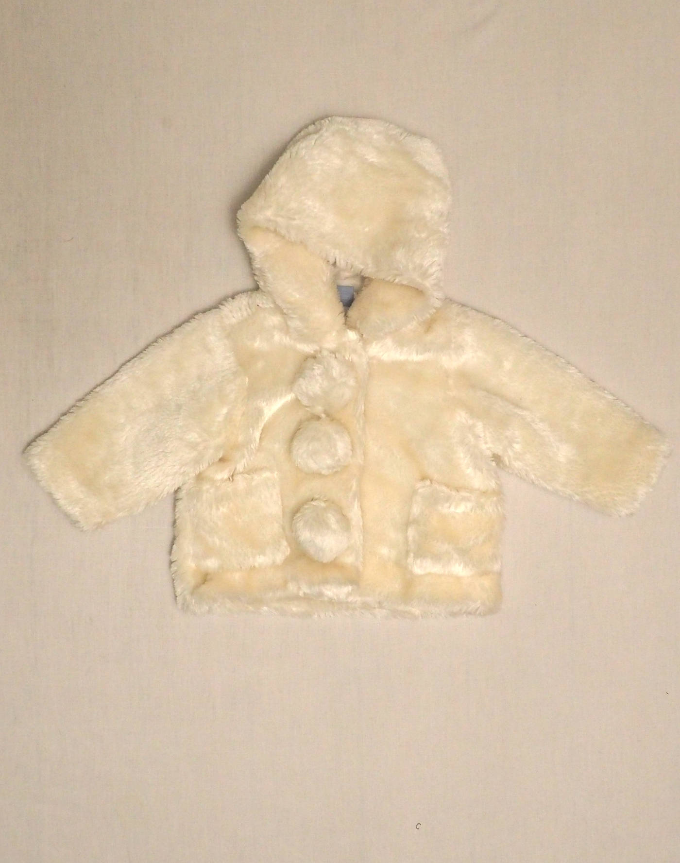 Faux fur coat with tassels