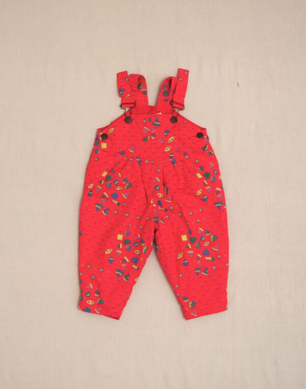Quilted overalls with cake motif