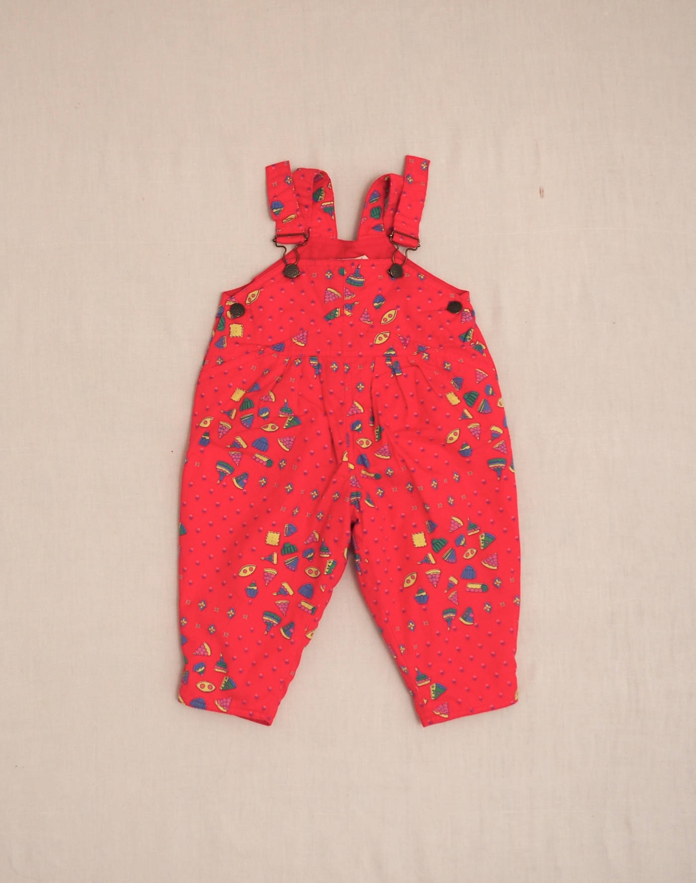 Quilted overalls with cake motif