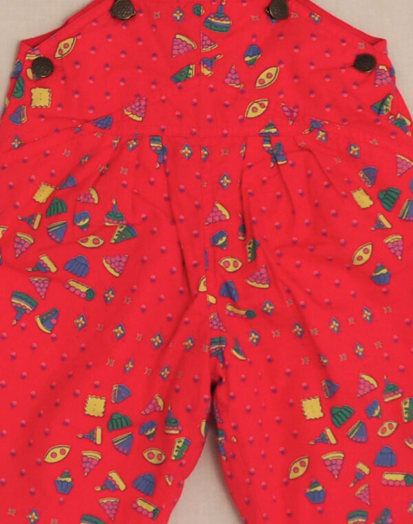 Quilted overalls with cake motif