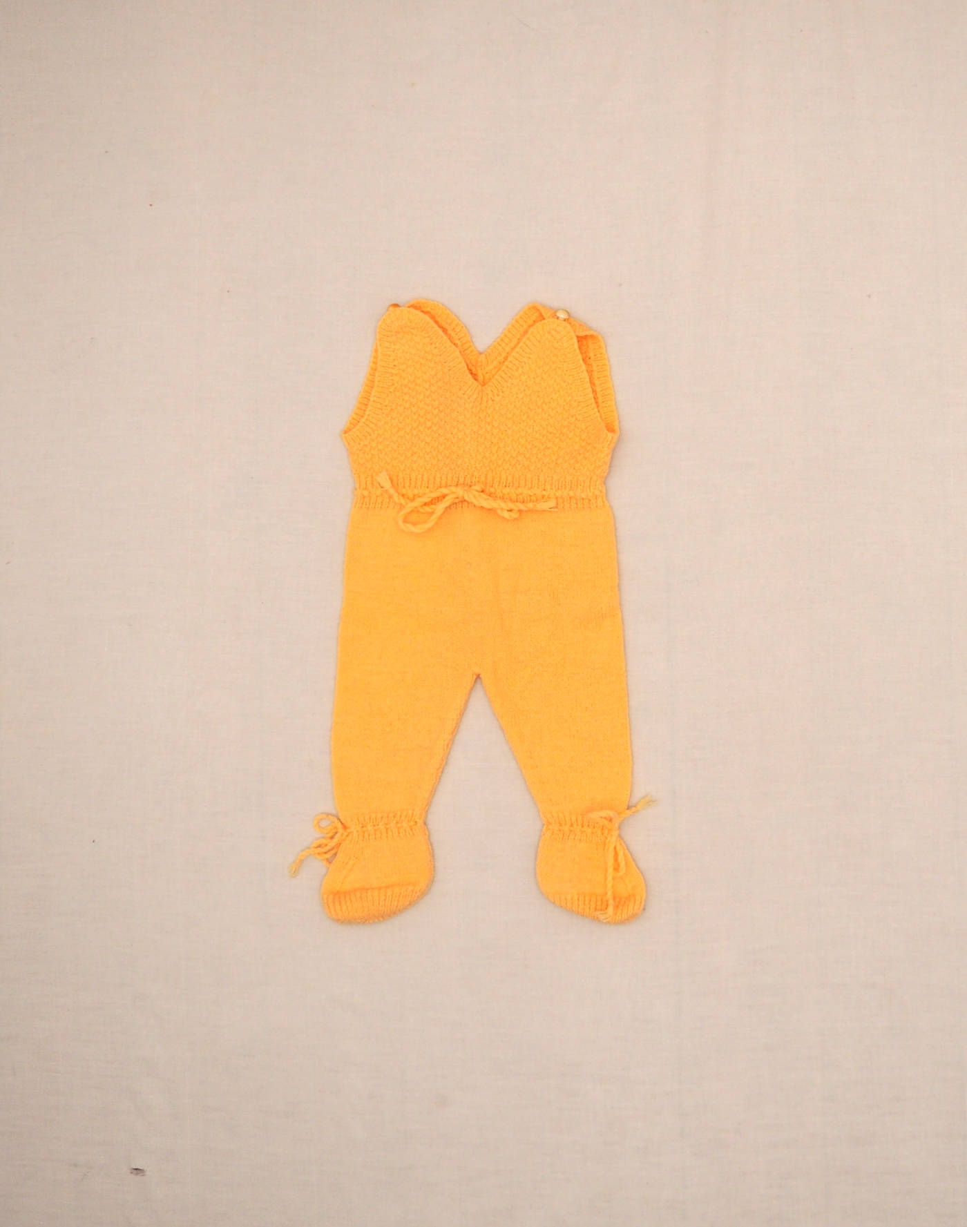 Hand-knitted yellow romper